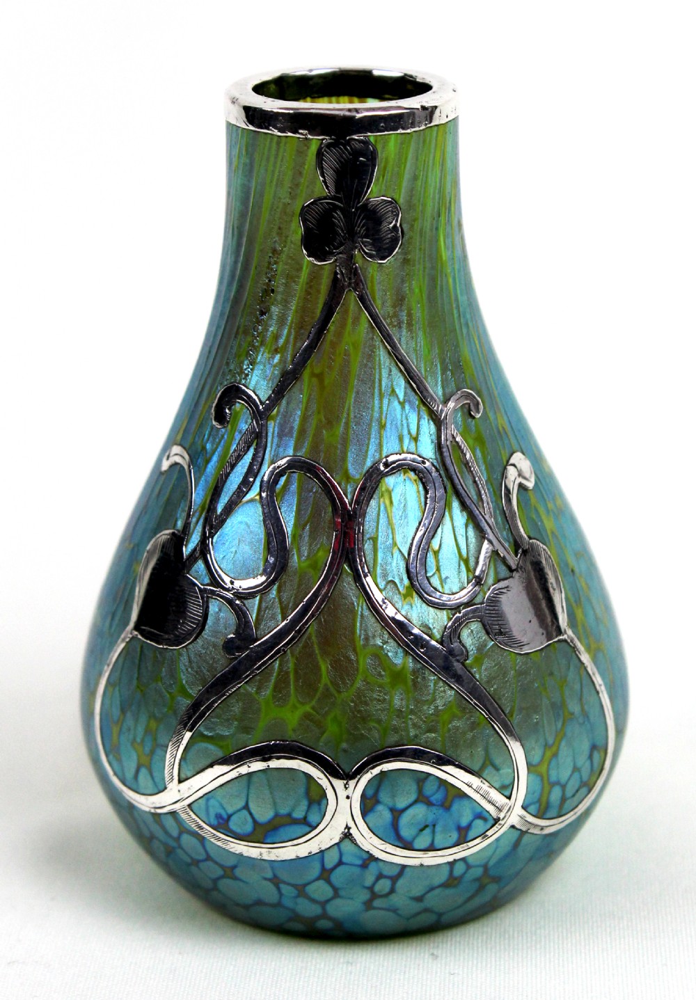 An iridescent blue and green glass vase featuring intricate silver overlay in a swirling Art Nouveau trefoil pattern. View IV