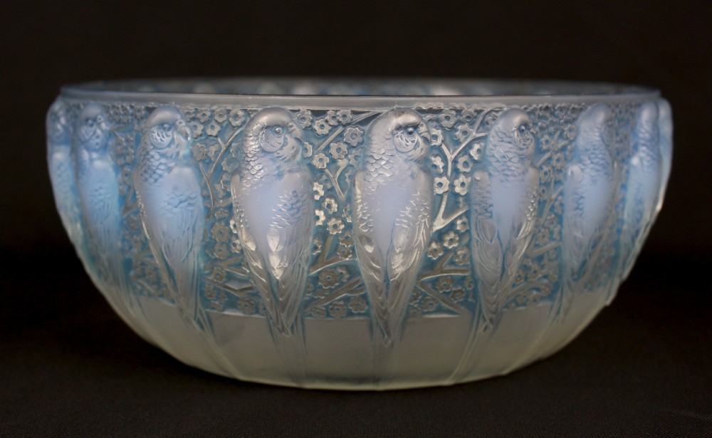 An Art Deco opalescent glass bowl decorated with a continuous molded relief pattern of parakeets perched among flowering branches.
