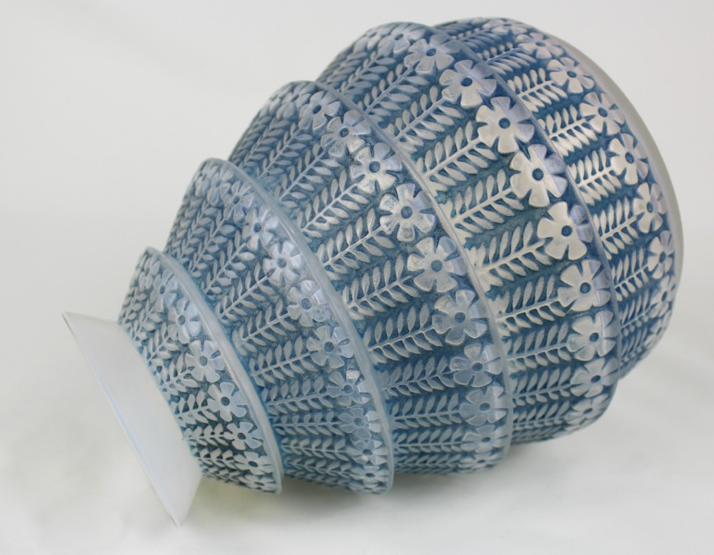 A conical frosted glass vase featuring stepped tiers with relief-moulded floral and leaf motifs highlighted in blue staining. View IV