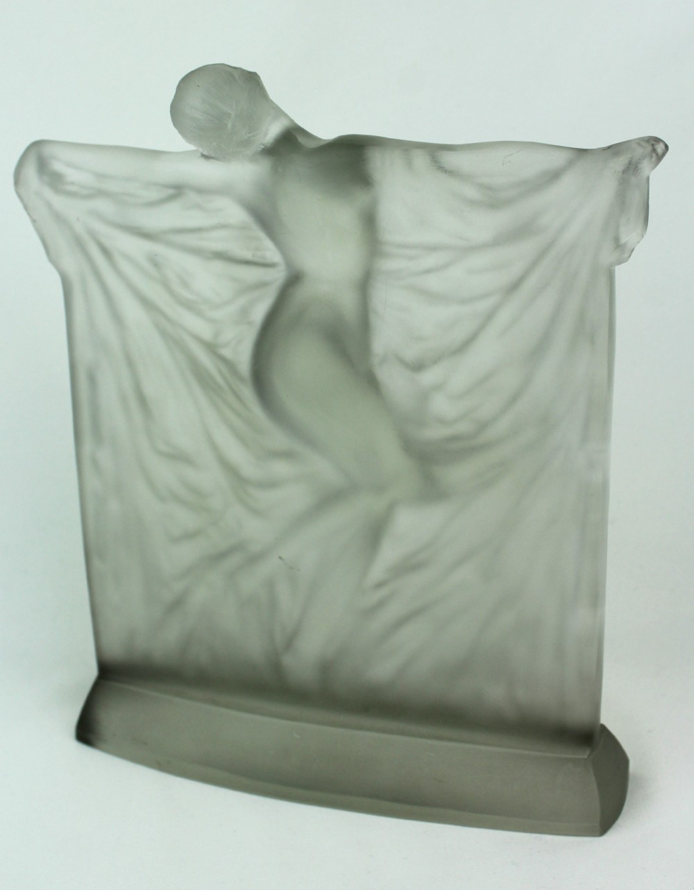 A frosted glass Art Deco statuette depicting a female figure with outstretched arms holding flowing drapery on a curved base. View IV