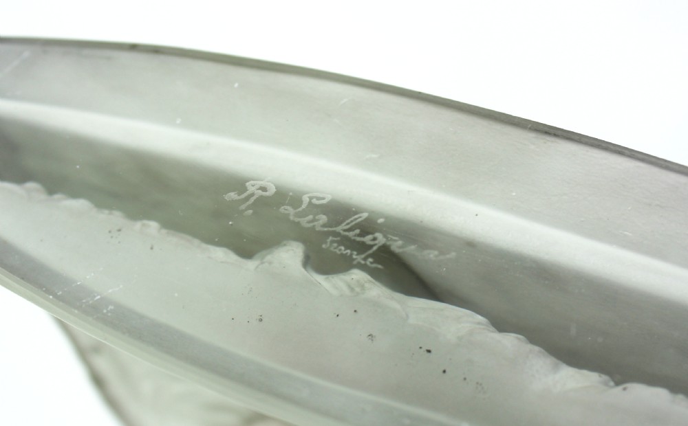 A frosted glass Art Deco statuette depicting a female figure with outstretched arms holding flowing drapery on a curved base. View VII