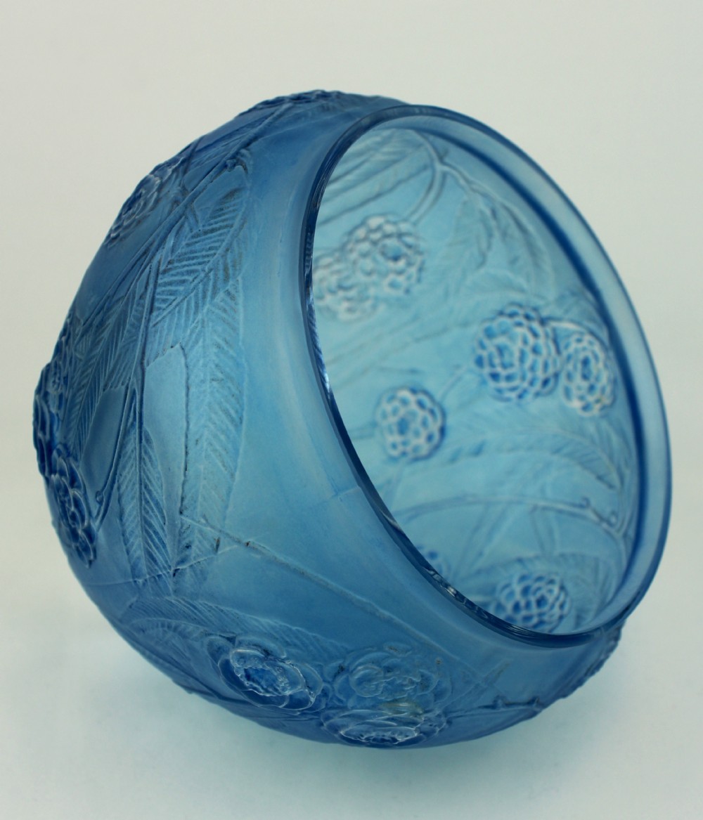 A spherical frosted blue glass vase decorated with moulded floral and leaf relief patterns across the exterior surface. View V