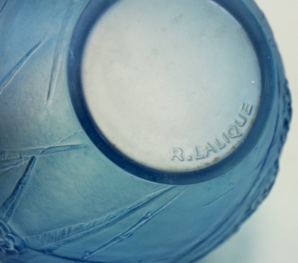 A spherical frosted blue glass vase decorated with moulded floral and leaf relief patterns across the exterior surface. View VI