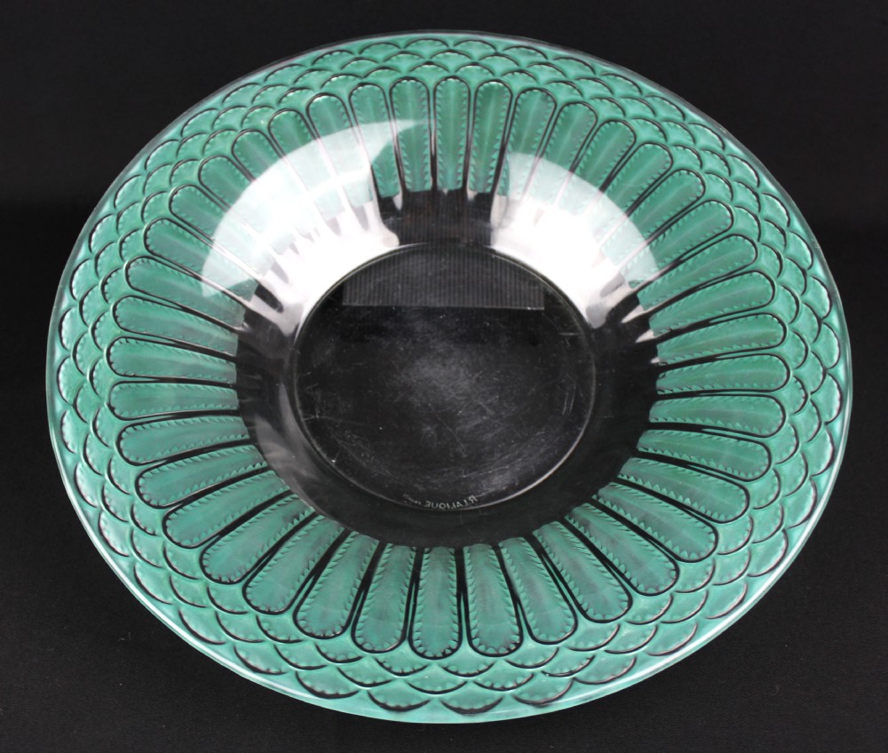 A circular Art Deco Rene Lalique clear glass bowl featuring a wide rim decorated with teal green stained geometric scalloped motifs.