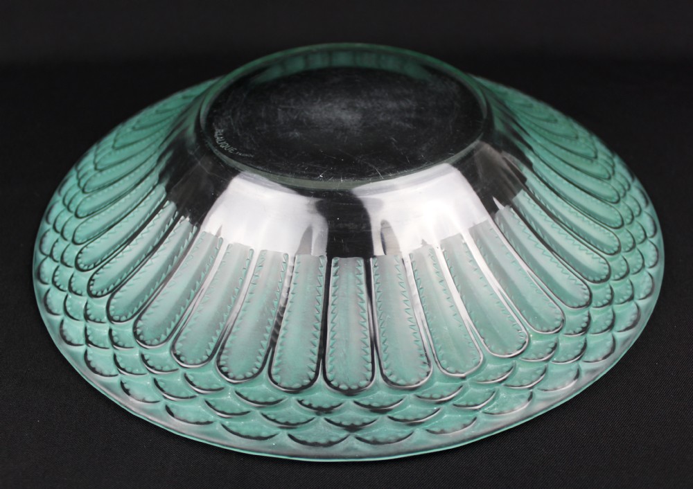 A circular Art Deco Rene Lalique clear glass bowl featuring a wide rim decorated with teal green stained geometric scalloped motifs. View IV