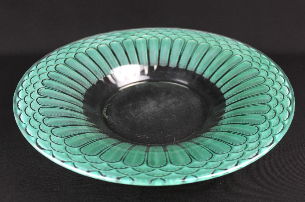 A circular Art Deco Rene Lalique clear glass bowl featuring a wide rim decorated with teal green stained geometric scalloped motifs. View VI