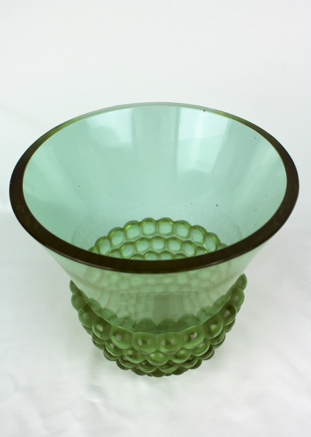 An Art Deco green glass vase featuring a smooth flared upper body and a base textured with raised spherical cabochons. View II