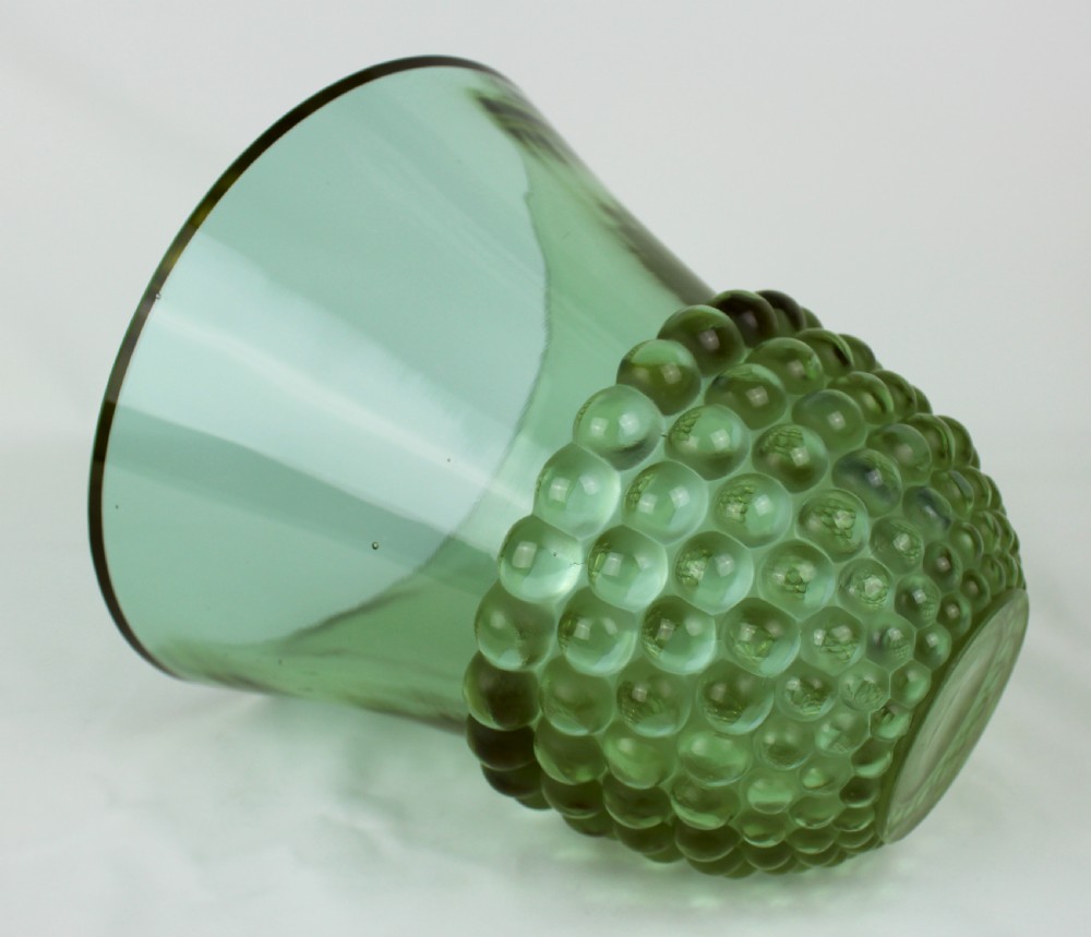 An Art Deco green glass vase featuring a smooth flared upper body and a base textured with raised spherical cabochons. View V