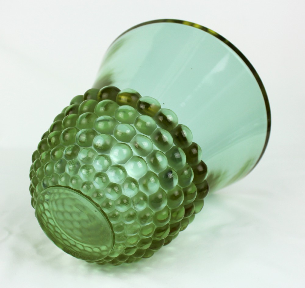 An Art Deco green glass vase featuring a smooth flared upper body and a base textured with raised spherical cabochons. View VI