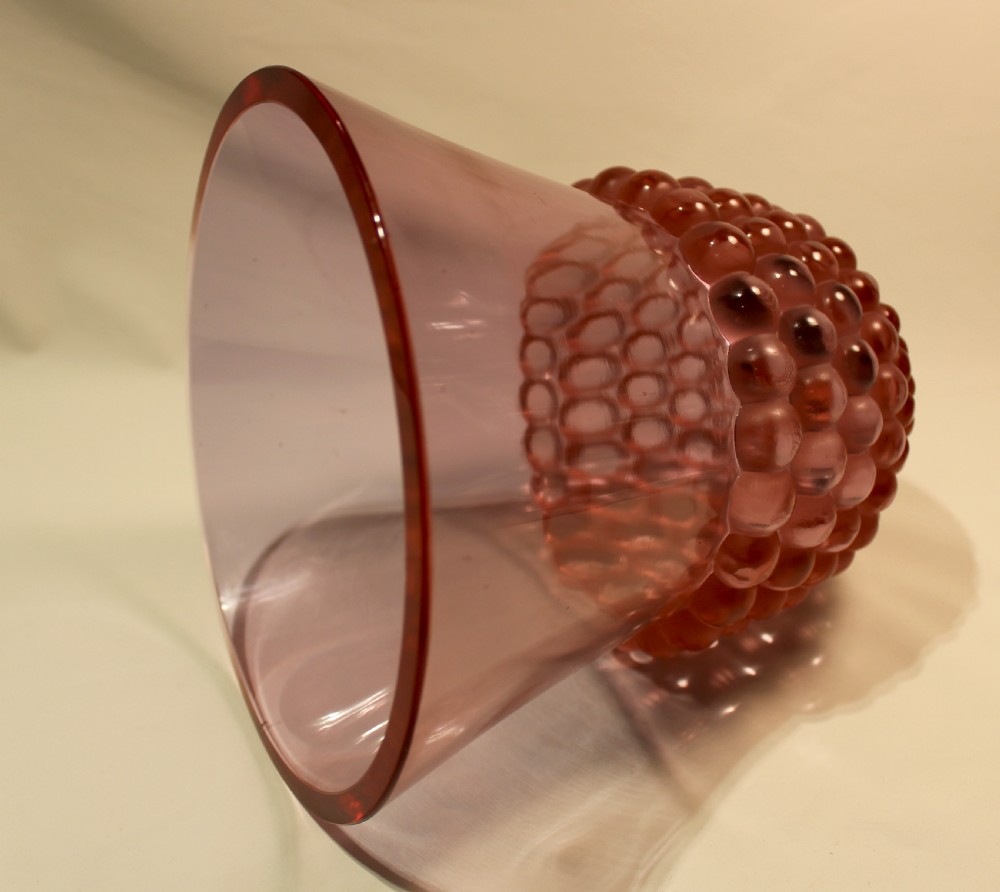 An Art Deco green glass vase featuring a smooth flared upper body and a base textured with raised spherical cabochons. View X