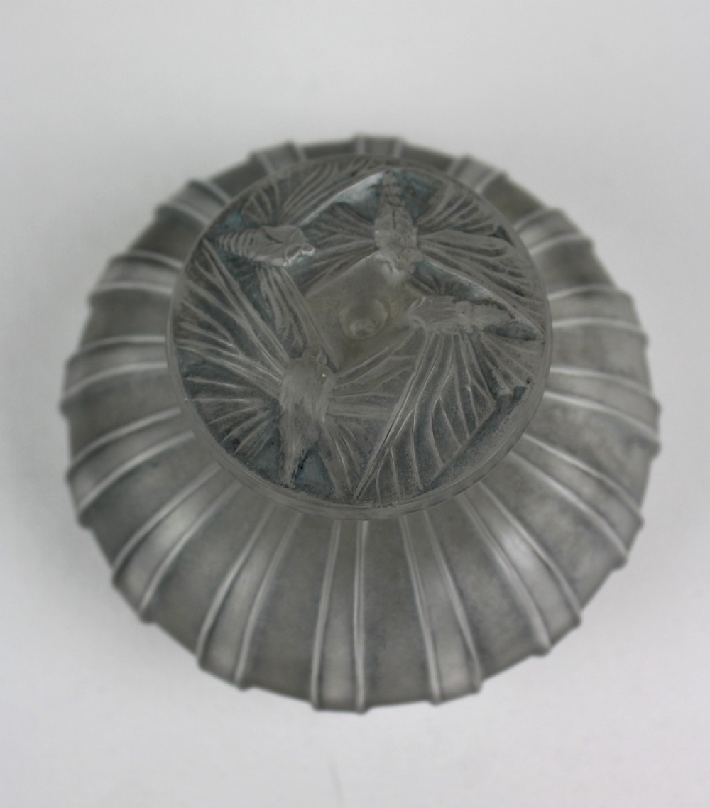 A ribbed frosted grey glass scent bottle featuring a round flat stopper moulded with butterfly relief details. View II