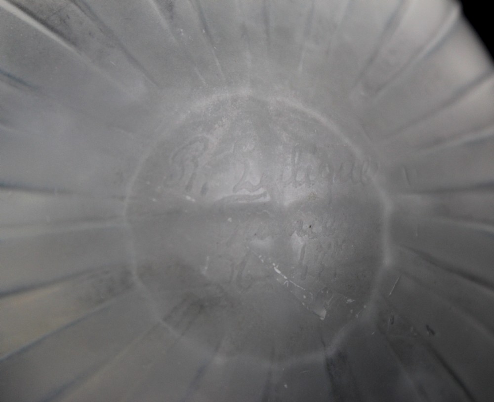 A ribbed frosted grey glass scent bottle featuring a round flat stopper moulded with butterfly relief details. View VII