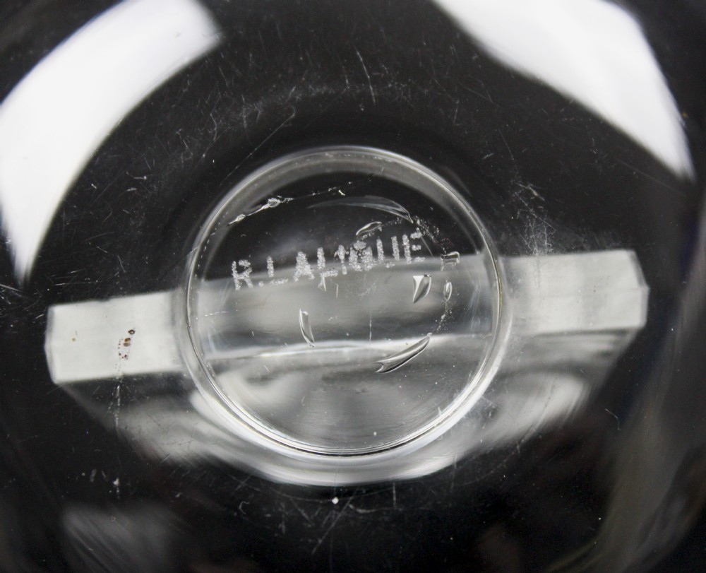 A clear glass pin dish featuring an upright arched centrepiece with a frosted glass relief depiction of a nymph surrounded by swirling beaded patterns. View II