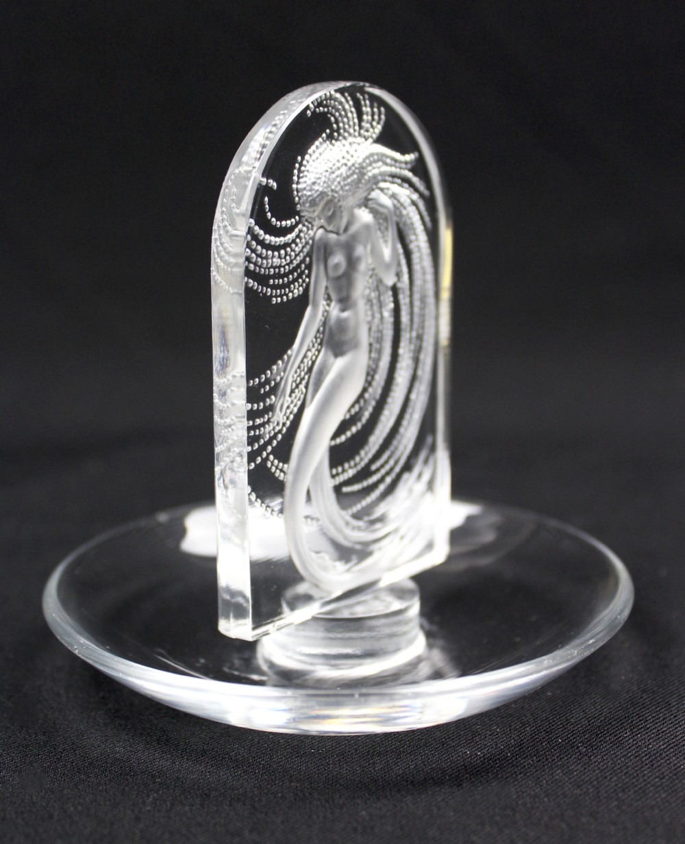 A clear glass pin dish featuring an upright arched centrepiece with a frosted glass relief depiction of a nymph surrounded by swirling beaded patterns. View IV