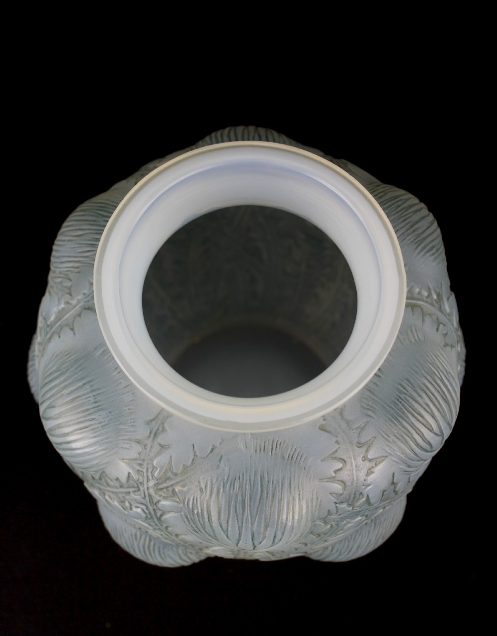 An Art Deco opalescent frosted glass vase featuring relief-moulded thistle motifs with translucent blue tones. View V