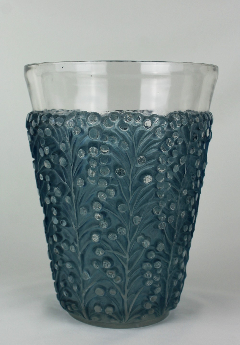 An Art Deco Rene Lalique Saint Tropez vase in clear and frosted blue-stained glass featuring a raised foliage and berry relief pattern.