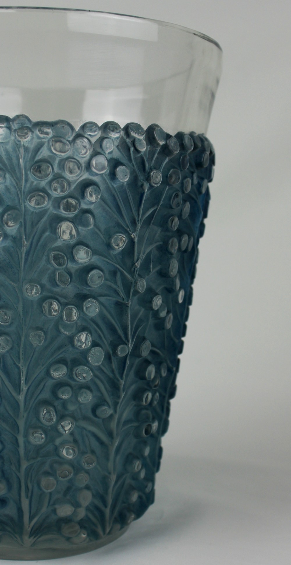An Art Deco Rene Lalique Saint Tropez vase in clear and frosted blue-stained glass featuring a raised foliage and berry relief pattern. View V