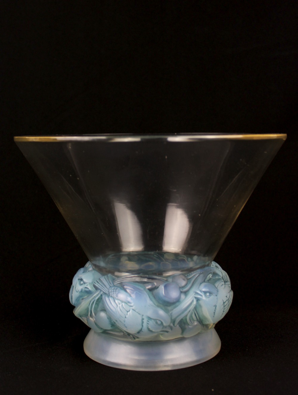 An Art Deco opalescent glass vase featuring a flared clear rim atop a base moulded with finches in foliage.