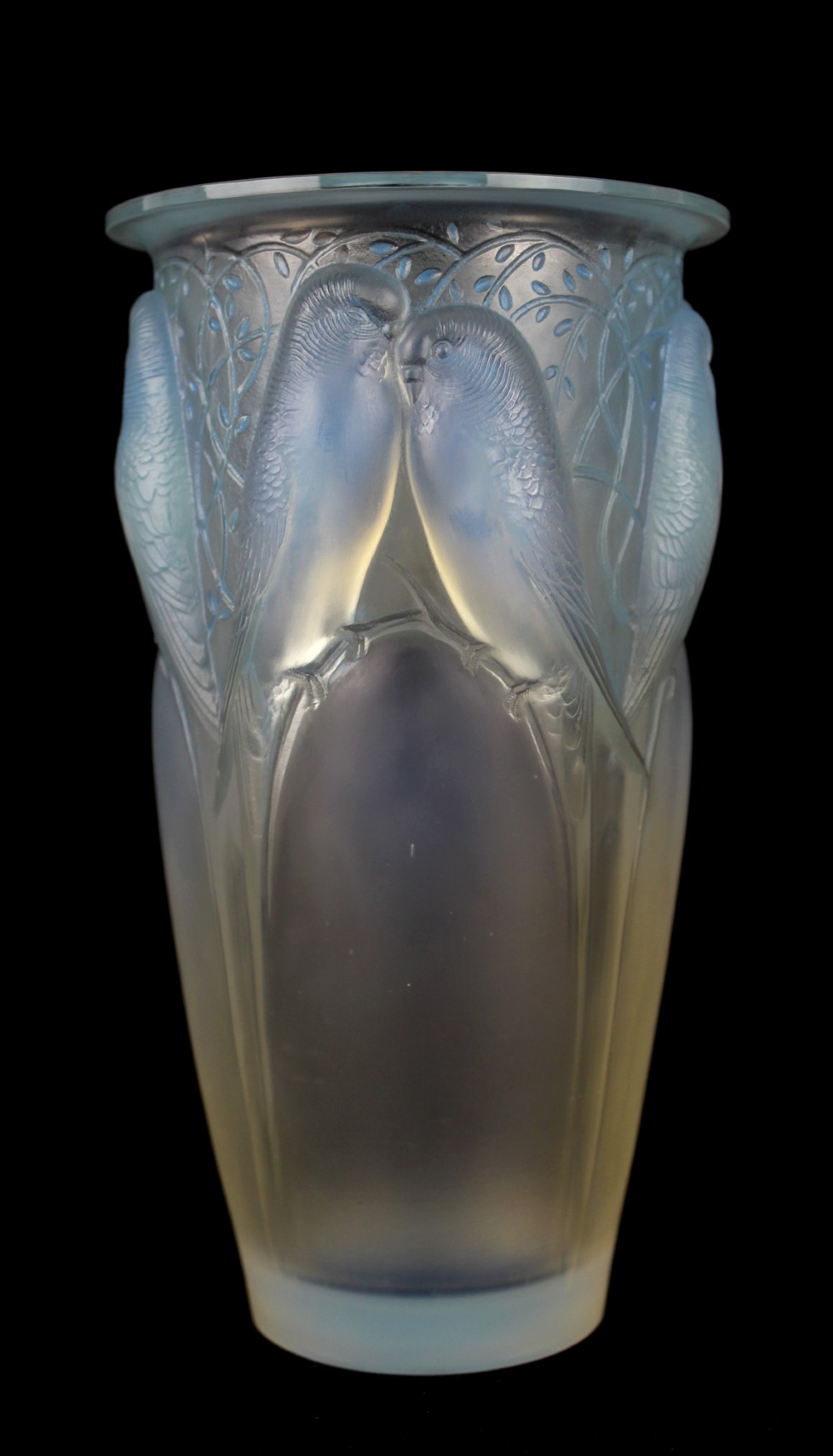 An Art Deco opalescent glass vase moulded in high relief with pairs of parakeets perched among stylized foliage.