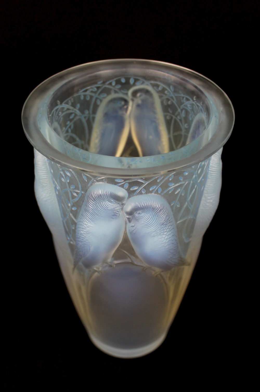 An Art Deco opalescent glass vase moulded in high relief with pairs of parakeets perched among stylized foliage. View II