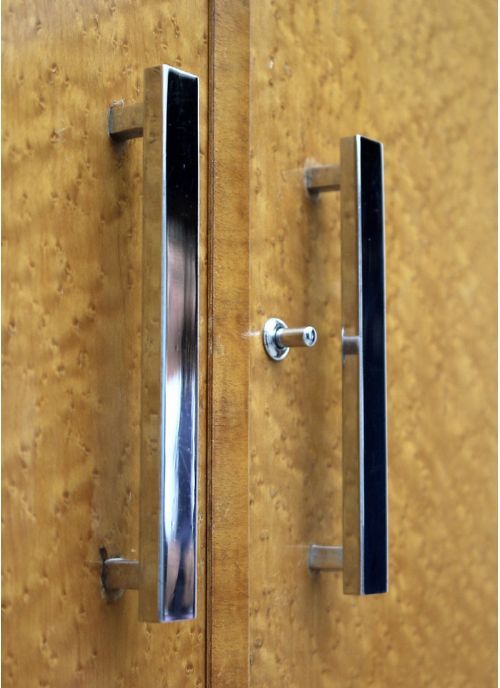 fig 1. A two-door Art Deco wardrobe crafted from light-toned birds eye maple veneer with vertically mounted chrome handles.