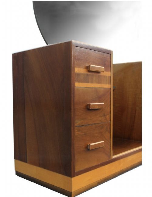 fig 1. An Art Deco walnut dressing table featuring a large circular mirror mounted above twin three-drawer pedestals and a central open recess with a glass shelf.