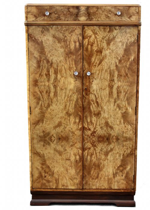 fig 1. An Art Deco figured walnut tallboy cabinet featuring a top drawer and double doors with book-matched wood grain.