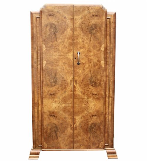 fig 1. A freestanding 1930s Art Deco single wardrobe featuring book-matched burr walnut veneer doors with a rounded top edge and block feet.
