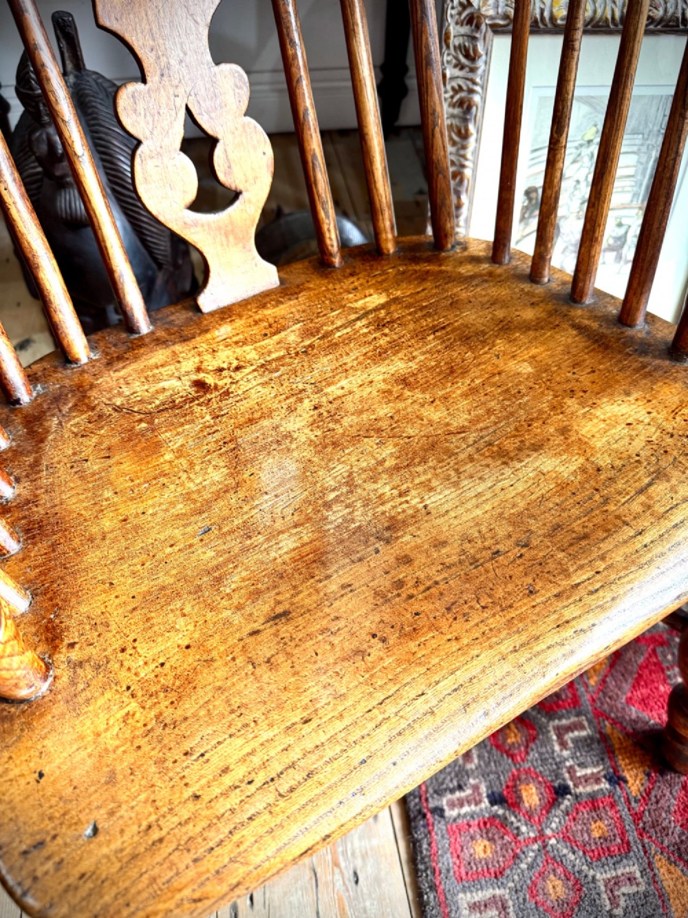 A 19th-century high-back Windsor armchair featuring a steam-bent hoop back, pierced central splat, shaped elm seat, and turned wooden legs. View IV