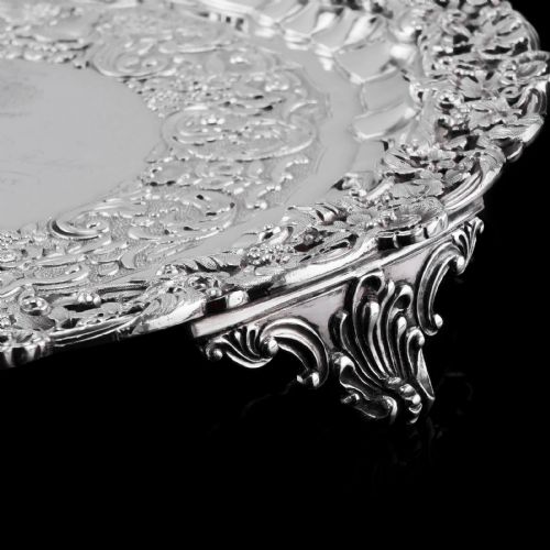 fig 5. A circular Georgian sterling silver salver featuring an intricately detailed cast floral border and central inscription engraving.