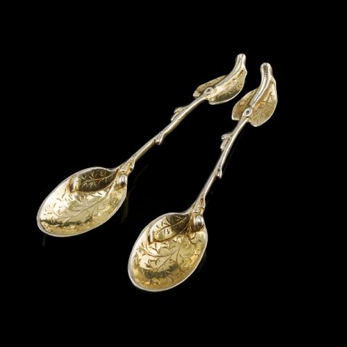 fig 1. A pair of Victorian silver-gilt serving spoons designed in a naturalistic motif with textured twig handles and leaf-engraved bowls.