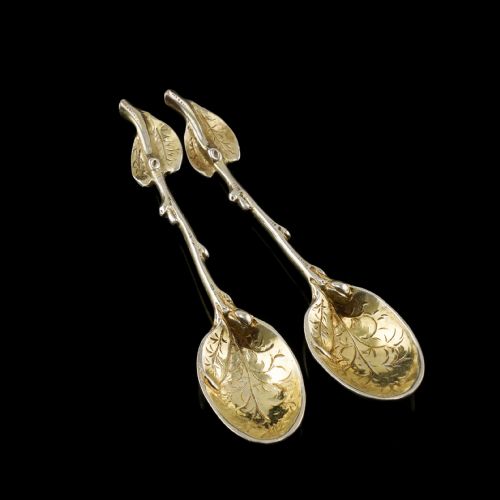 fig 2. A pair of Victorian silver-gilt serving spoons designed in a naturalistic motif with textured twig handles and leaf-engraved bowls.
