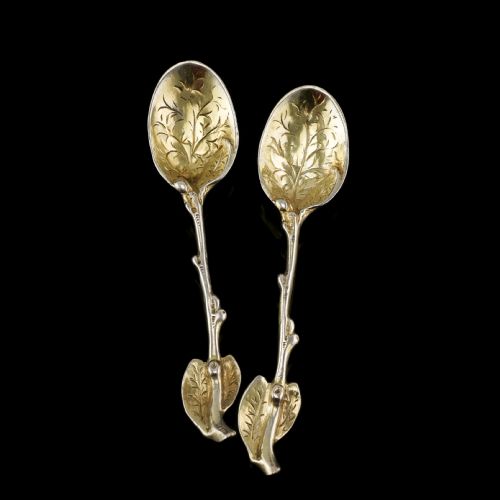 fig 3. A pair of Victorian silver-gilt serving spoons designed in a naturalistic motif with textured twig handles and leaf-engraved bowls.