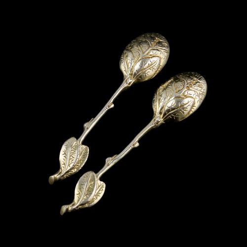 fig 4. A pair of Victorian silver-gilt serving spoons designed in a naturalistic motif with textured twig handles and leaf-engraved bowls.