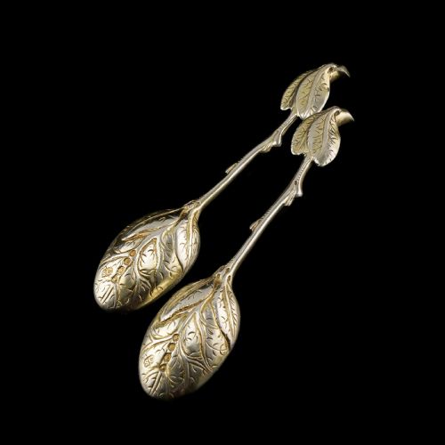 fig 6. A pair of Victorian silver-gilt serving spoons designed in a naturalistic motif with textured twig handles and leaf-engraved bowls.