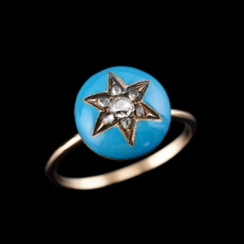 fig 2. A 9ct yellow gold ring featuring a bright blue enamel dome set with a central six-pointed diamond star motif.