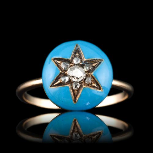 fig 3. A 9ct yellow gold ring featuring a bright blue enamel dome set with a central six-pointed diamond star motif.