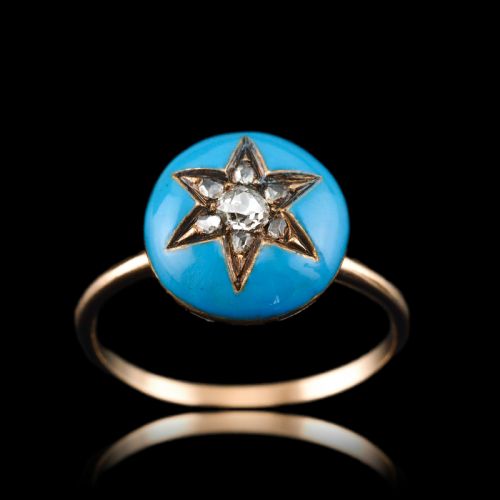fig 4. A 9ct yellow gold ring featuring a bright blue enamel dome set with a central six-pointed diamond star motif.