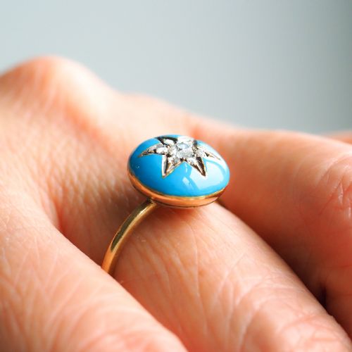fig 5. A 9ct yellow gold ring featuring a bright blue enamel dome set with a central six-pointed diamond star motif.