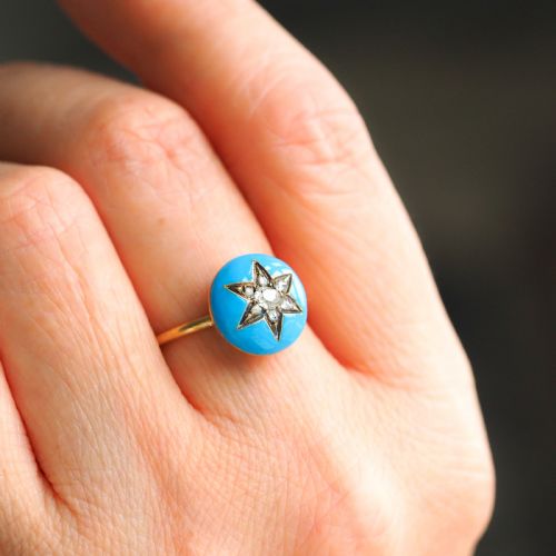 fig 7. A 9ct yellow gold ring featuring a bright blue enamel dome set with a central six-pointed diamond star motif.
