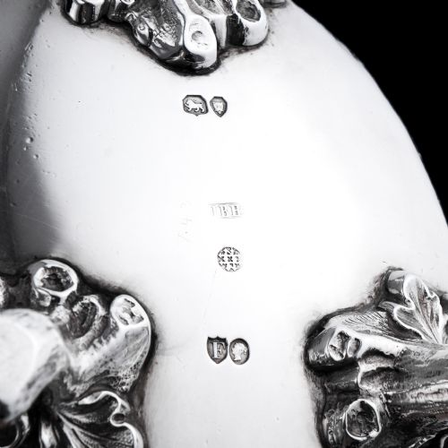 fig 4. A Victorian sterling silver sauce boat featuring an organic twig handle, acorn feet, and engraved crest detailing.
