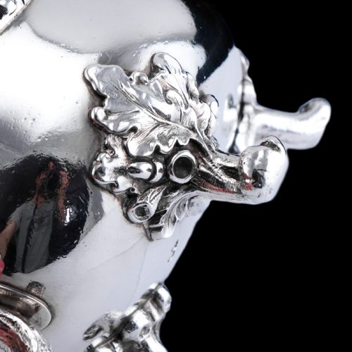 fig 8. A Victorian sterling silver sauce boat featuring an organic twig handle, acorn feet, and engraved crest detailing.
