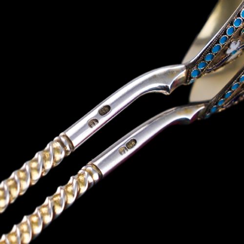 fig 7. A pair of late 19th-century Russian solid silver spoons featuring turquoise, blue, and white cloisonne enamel foliate decoration on silver-gilt teardrop bowls with twisted handles.