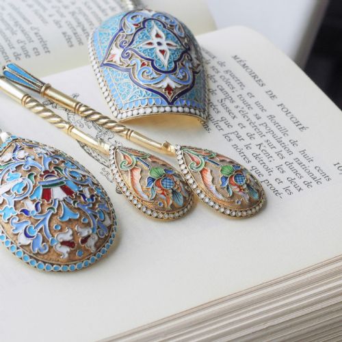 fig 1. A pair of late 19th-century Russian solid silver spoons featuring turquoise, blue, and white cloisonne enamel foliate decoration on silver-gilt teardrop bowls with twisted handles.