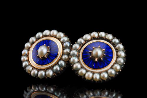 fig 6. A pair of Georgian circular gold earrings featuring cobalt blue guilloche enamel centres surrounded by concentric rings of white enamel and seed pearls.