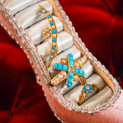 fig 2. A Victorian 15ct yellow gold crescent brooch set with alternating turquoise cabochons and split pearls, featuring an offset diamond trefoil motif.