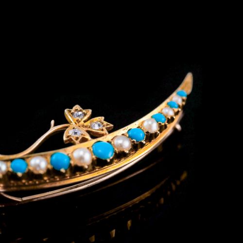 fig 3. A Victorian 15ct yellow gold crescent brooch set with alternating turquoise cabochons and split pearls, featuring an offset diamond trefoil motif.