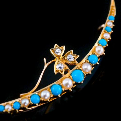fig 4. A Victorian 15ct yellow gold crescent brooch set with alternating turquoise cabochons and split pearls, featuring an offset diamond trefoil motif.