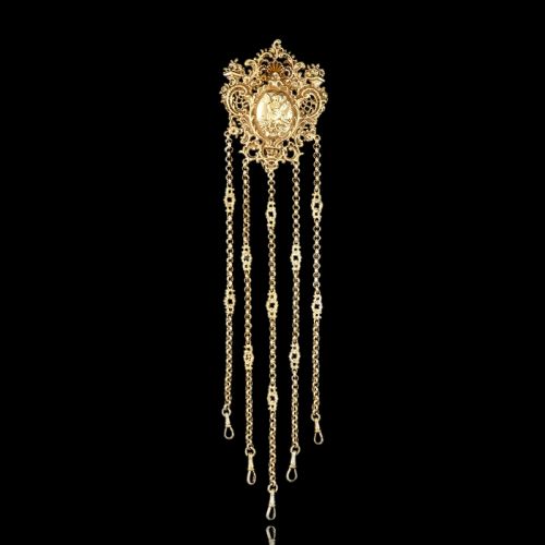 fig 4. An ornate Victorian silver-gilt chatelaine featuring five hanging chains with swivel clips and a rococo plaque detailed with a central cherub motif.
