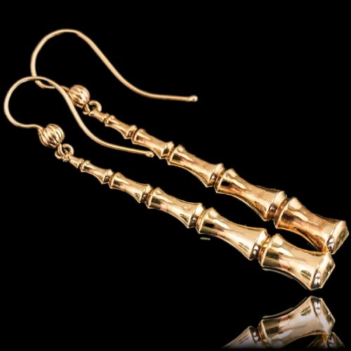 fig 1. A pair of 9ct yellow gold drop earrings designed with stacked bamboo node motifs hanging from shepherd hook ear wires.